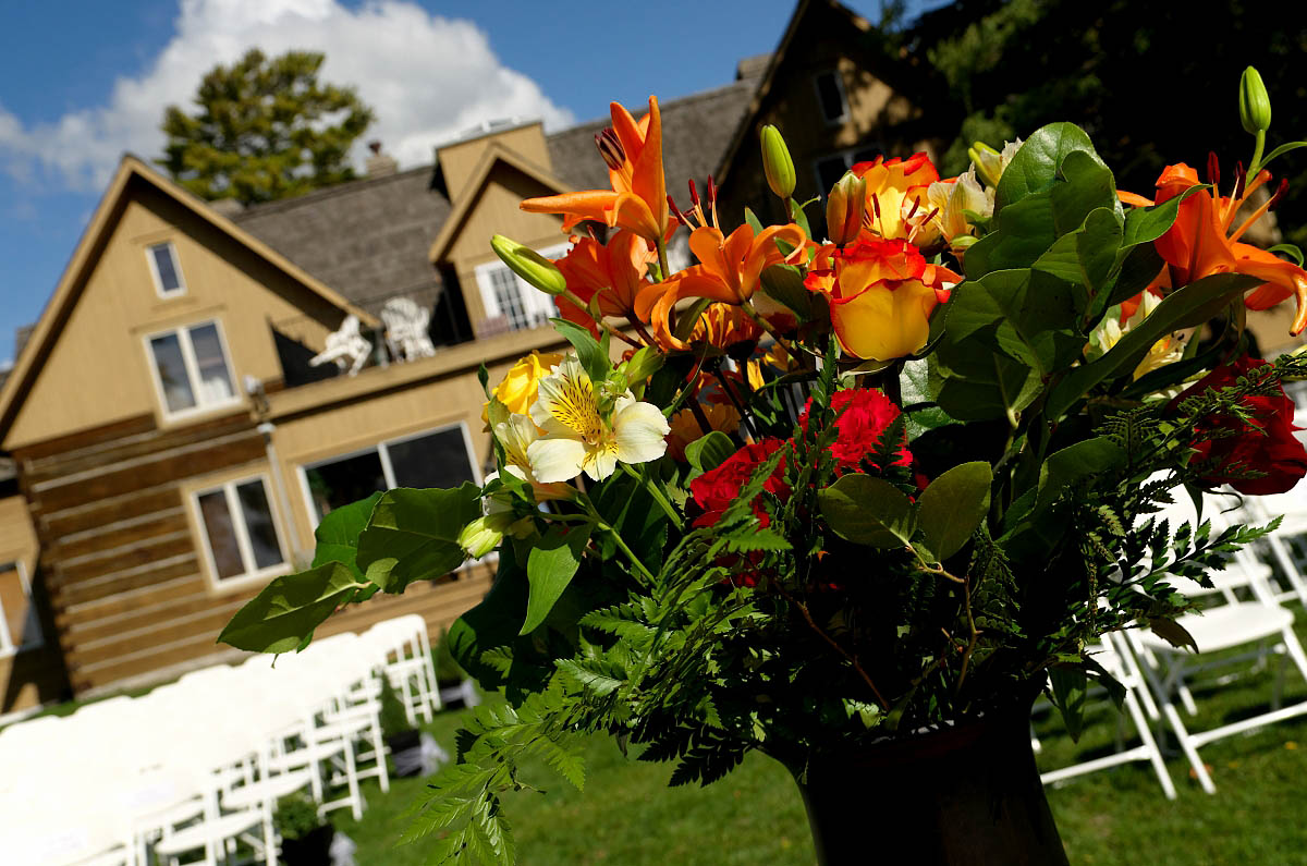 Wedding bouquet and ceremony chairs lined up in front of the historic Dunsford House at Eganridge Resort in Fenelon Falls near Bobcaygeon