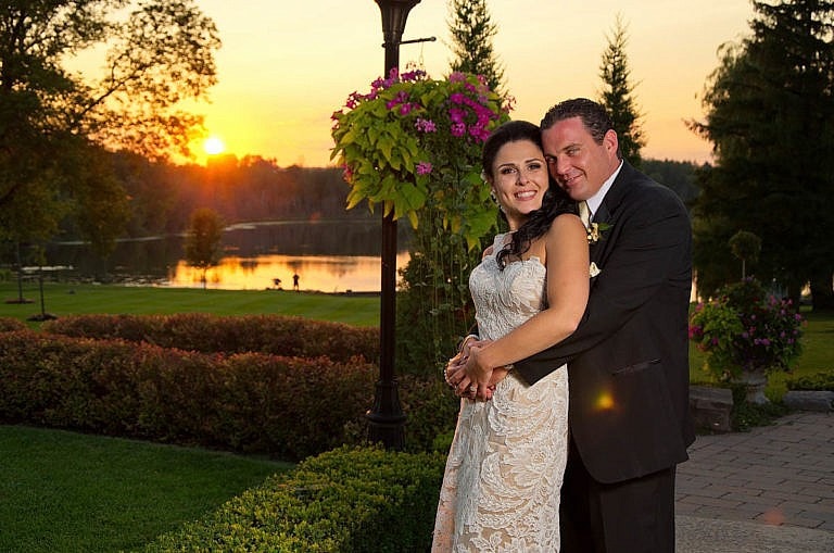 bride and groom embrace at sunset in garden at Royal Ambassador wedding in Caledon