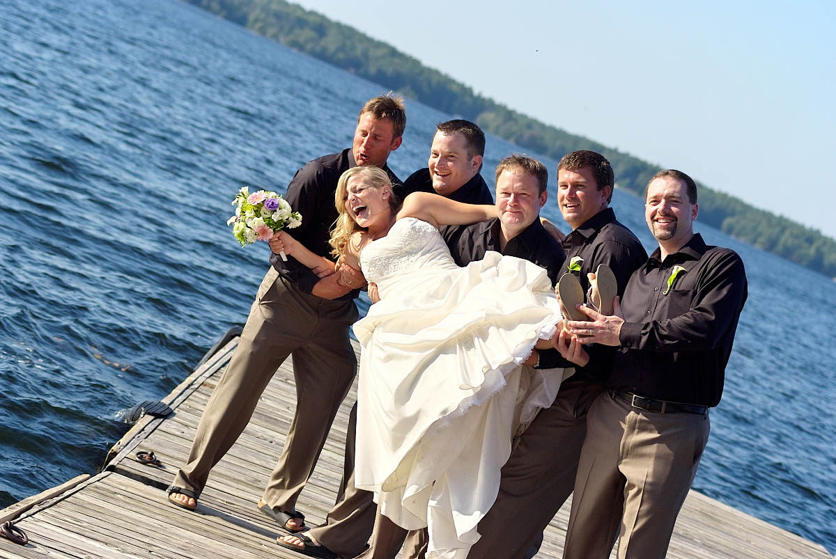 Groomsmen about to Throw bride in Water