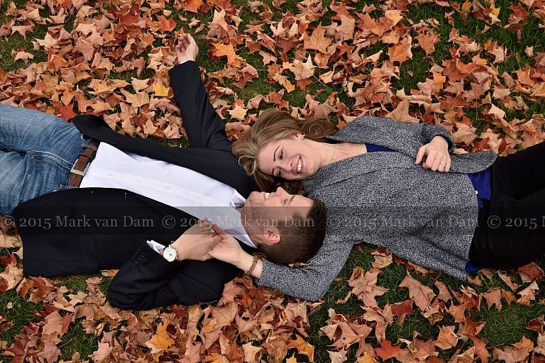 Couple lying head to head in fall leaves
