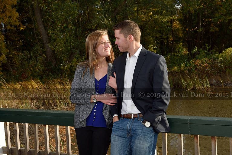 Stylish couple leans against boathouse railing at Leacock Museum engagement photography session