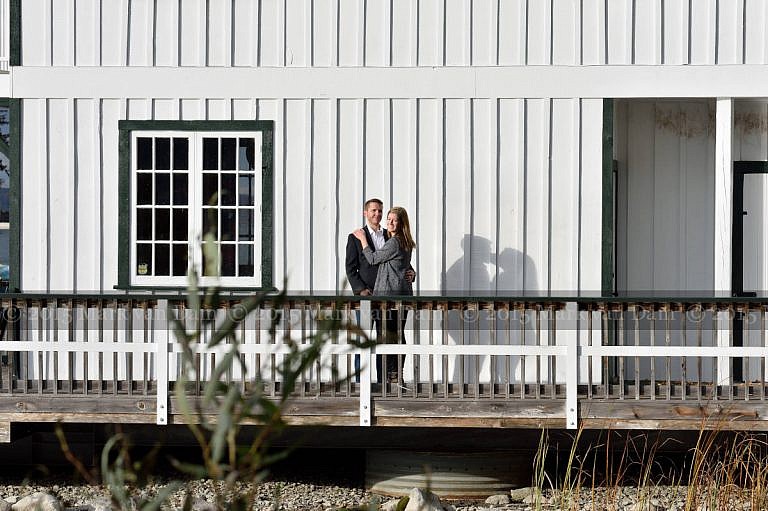 Couple by boathouse at Stephen Leacock Museum, with their shadows kissing