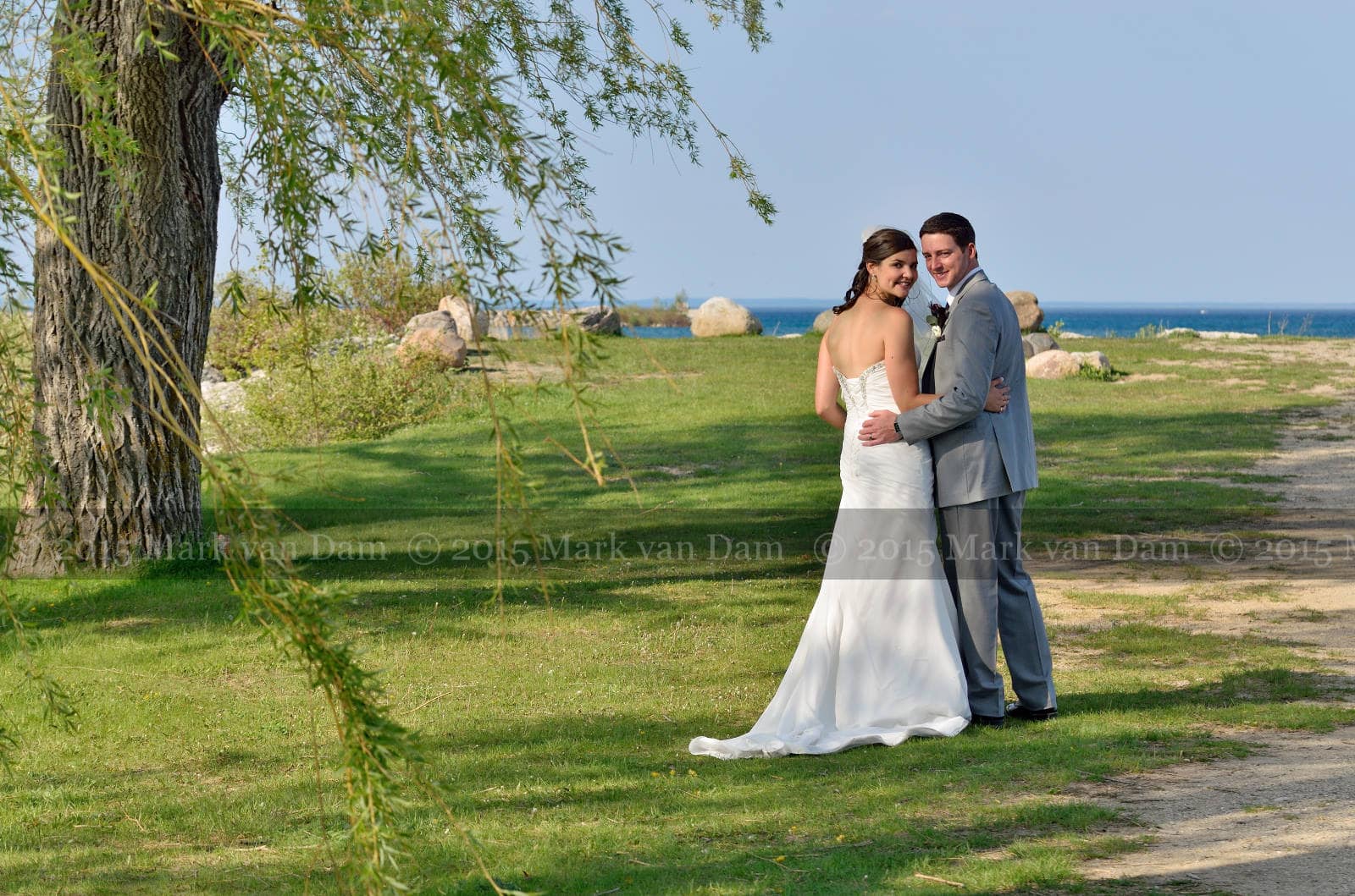 Bear Estate Wedding in Collingwood, couple strolling beneath the willow trees by Georgian Bay in Collingwood