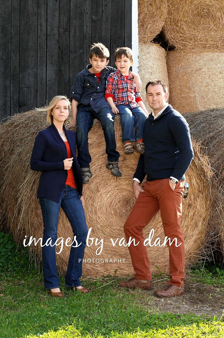 Stylish Family Poses by Hay Bale at Family Farm stayner photographer barrie photographer family portraits wasaga photographer collingwood photographer