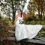 Beautiful Bride Sits on Split Rail Fence