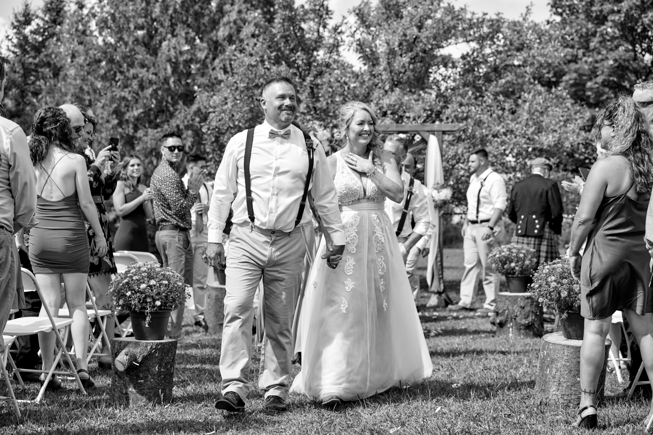 An emotional Bride and Groom Walking Down Aisle Together at Rustic Country Wedding