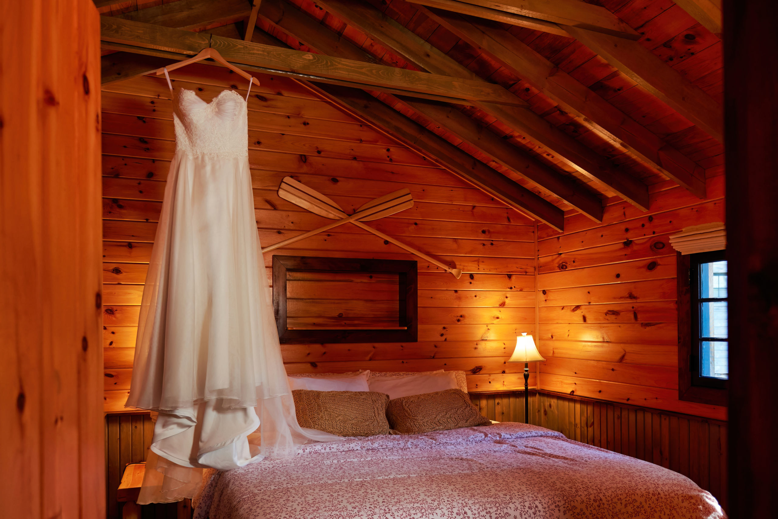 Wedding Dress Hanging from Beams in Cabin at the Lodge at Pine Cove