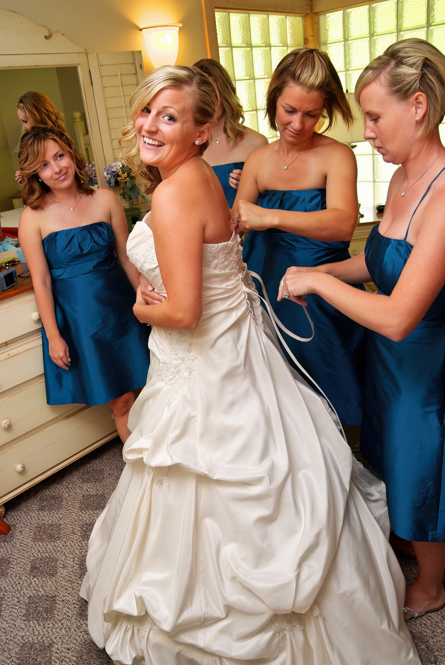 Bride Getting Ready with the help of her Bridesmaids
