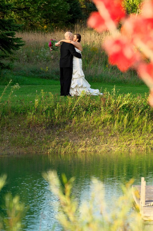 bride and groom kiss in fall at belcroft