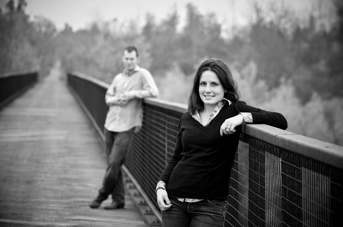 Young couple on trestle bridge at Orange corners engagement session near Omemee, Lindsay, and Peterborough