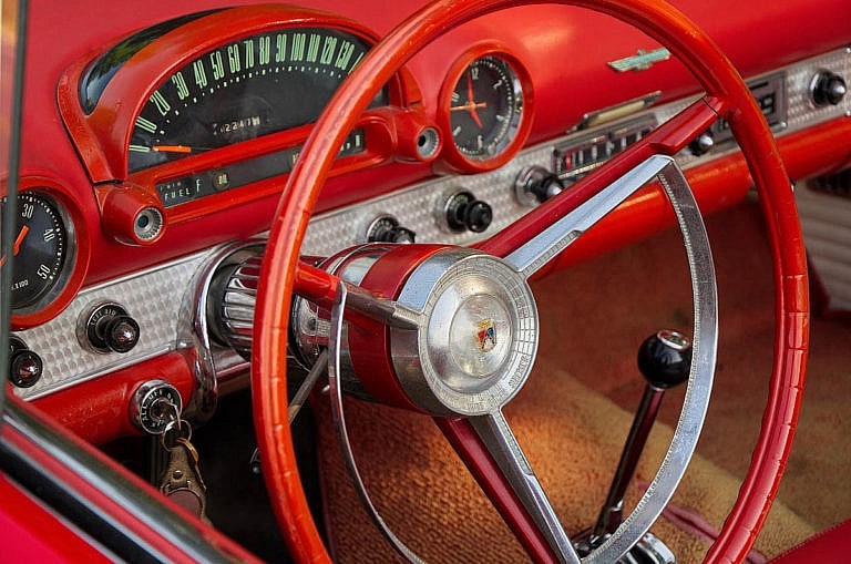 close up of red thunderbird steering wheel