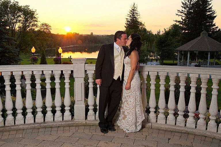 bride and groom kiss at sunset in garden at Royal Ambassador wedding in Caledon