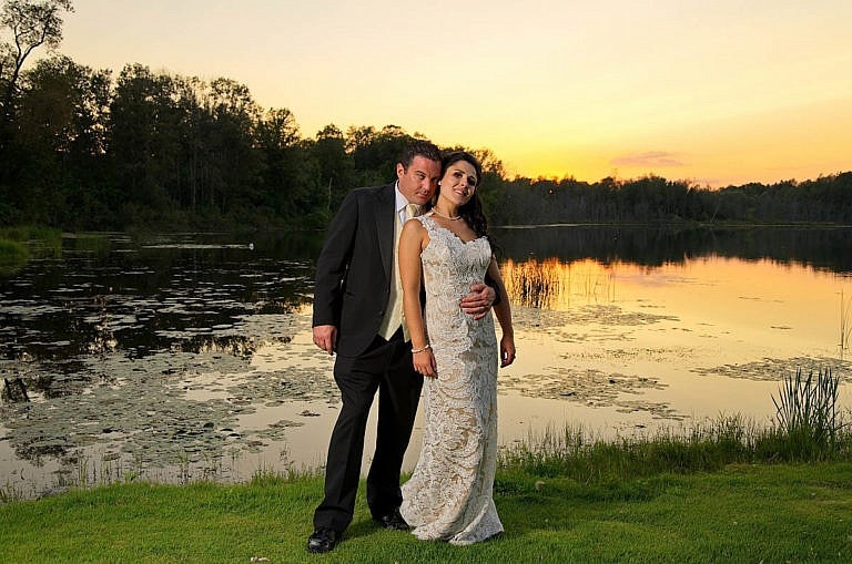 bride and groom in front of pond at sunset at caledon wedding at Royal ambassador