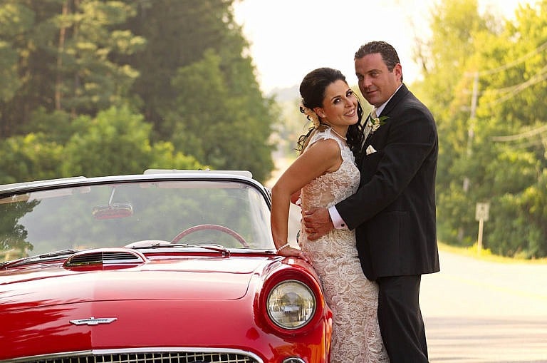 Couple with cherry red vintage car at Caledon wedding at Royal Ambassador