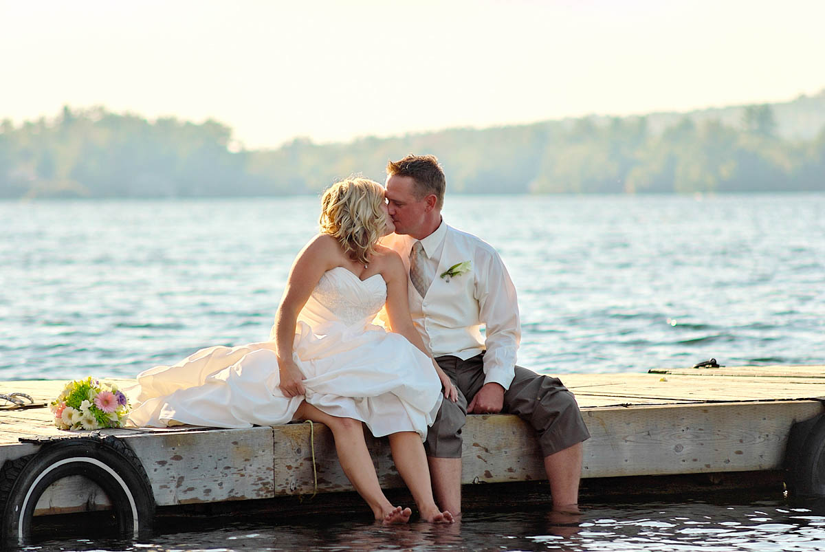 Wwedding couple kisses on dock at Irwin Inn Wedding