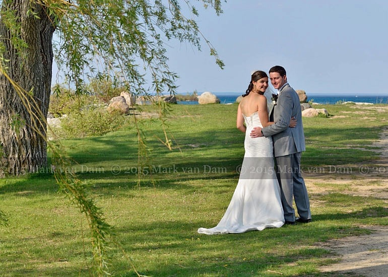 Bear Estate Wedding in Collingwood, couple strolling beneath the willow trees by Georgian Bay in Collingwood