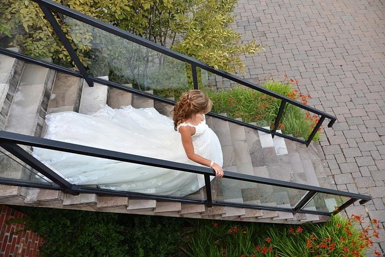 Bride descending stairs at The Club at Bond Head