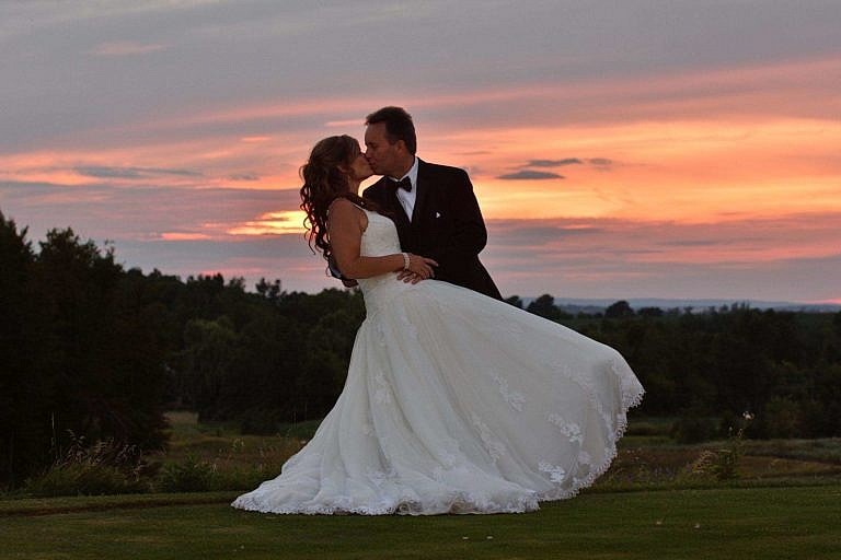 Bride and Groom embrace at sunset at the Club at Bond Head