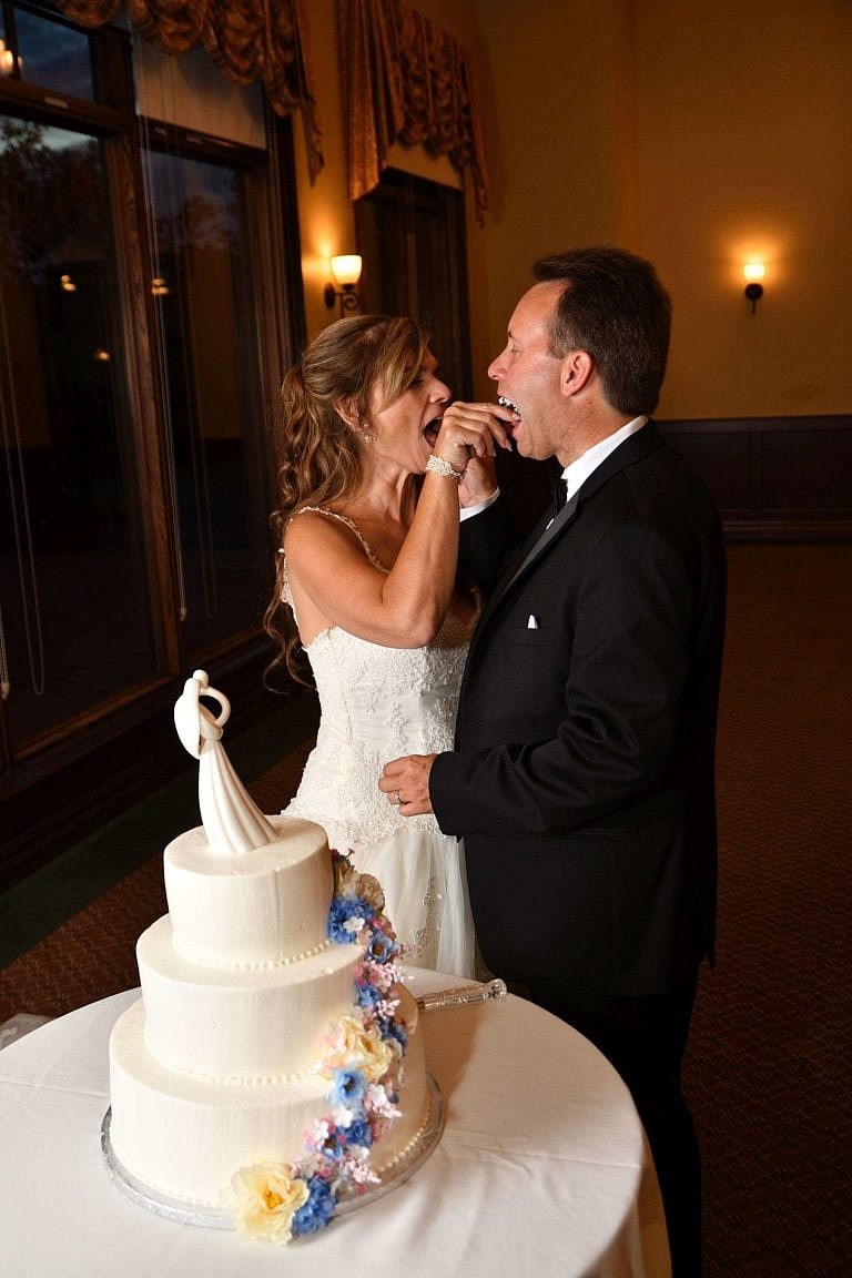 wedding couple feeds cake to each other at bond head wedding