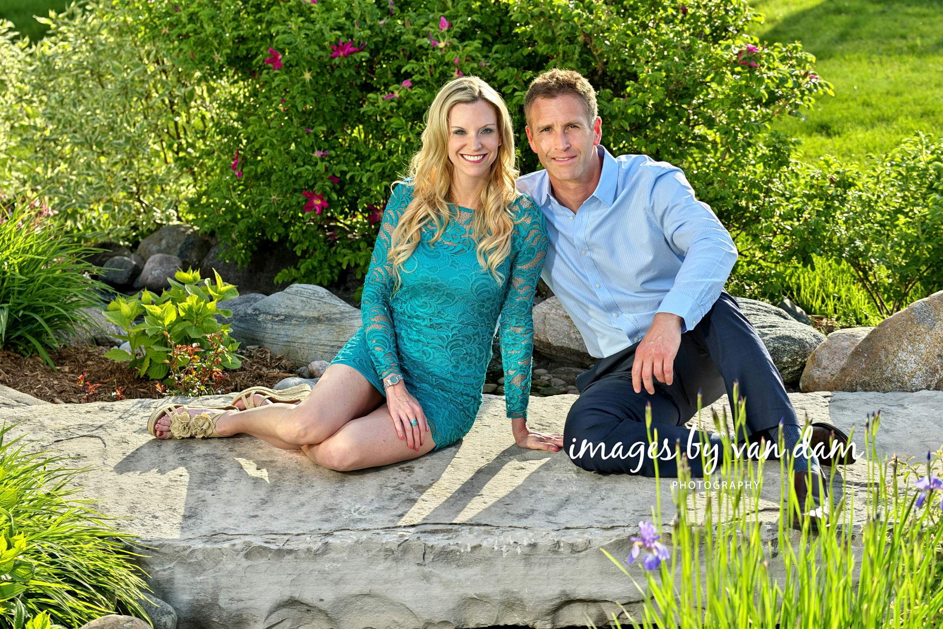 Stylish couple sits on flat rock in rose garden collingwood photographer collingwood portraits