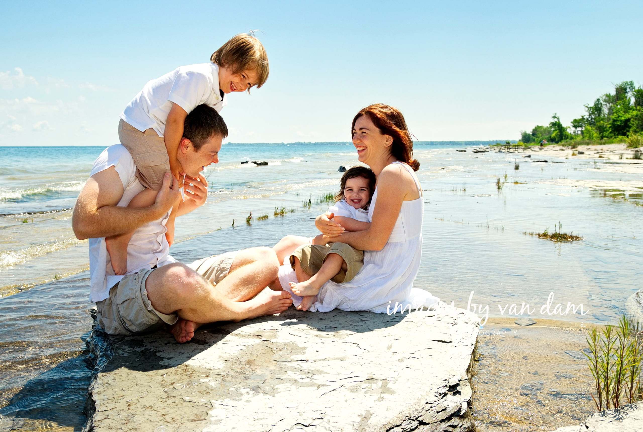 A young Family Enjoys a Lovely Moment on the Shale Beach at Craigleith Park
