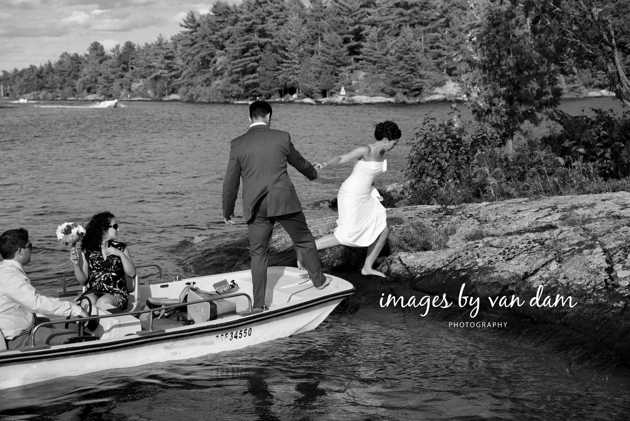 A bride hops off a motorboat onto an island for a wedding photography session