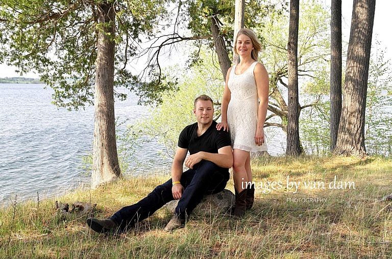 Couple by lake in Bridgenorth, Ontario at country themed engagement session