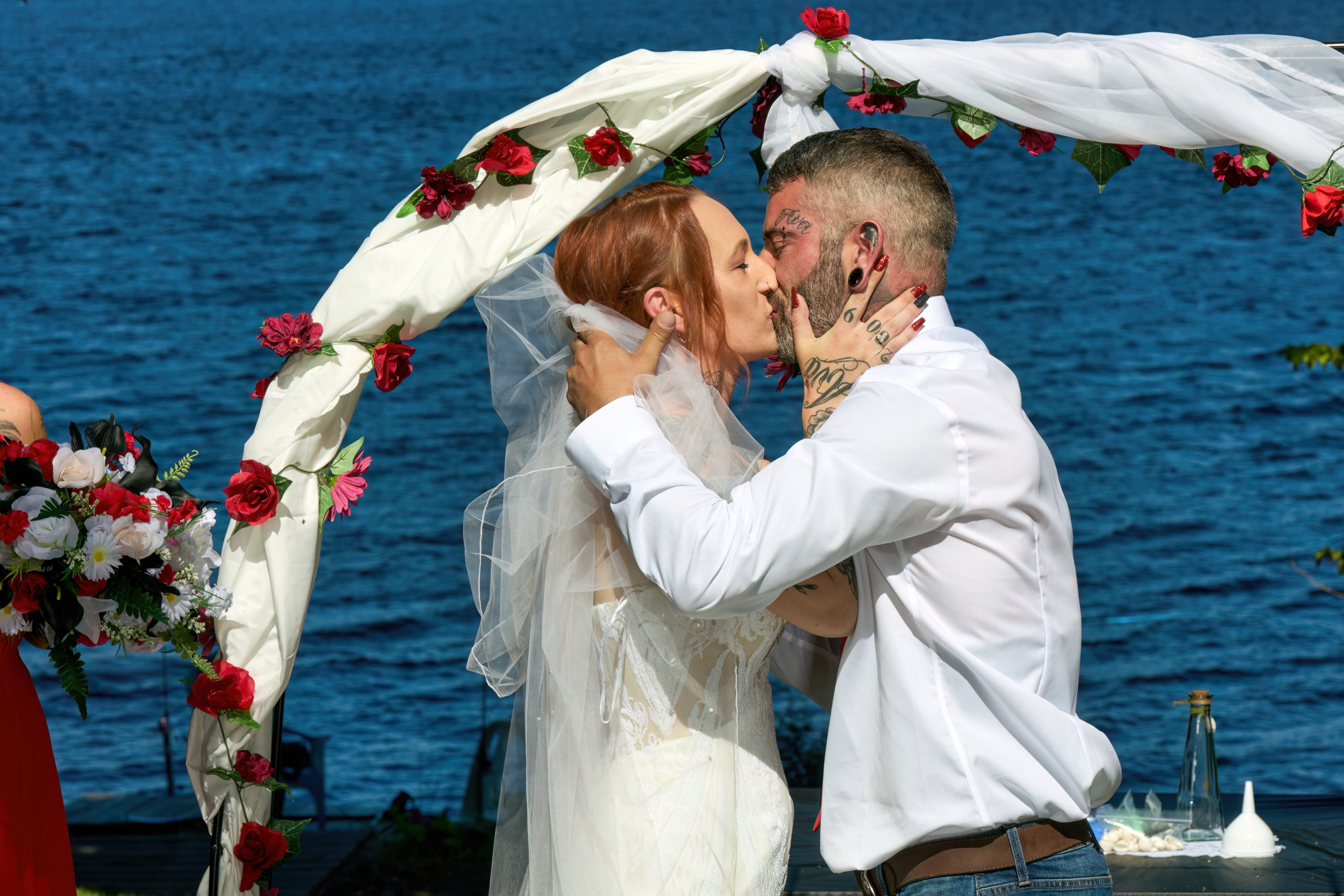 Bride and Groom Kiss during waterfront ceremony at Muskoka wedding