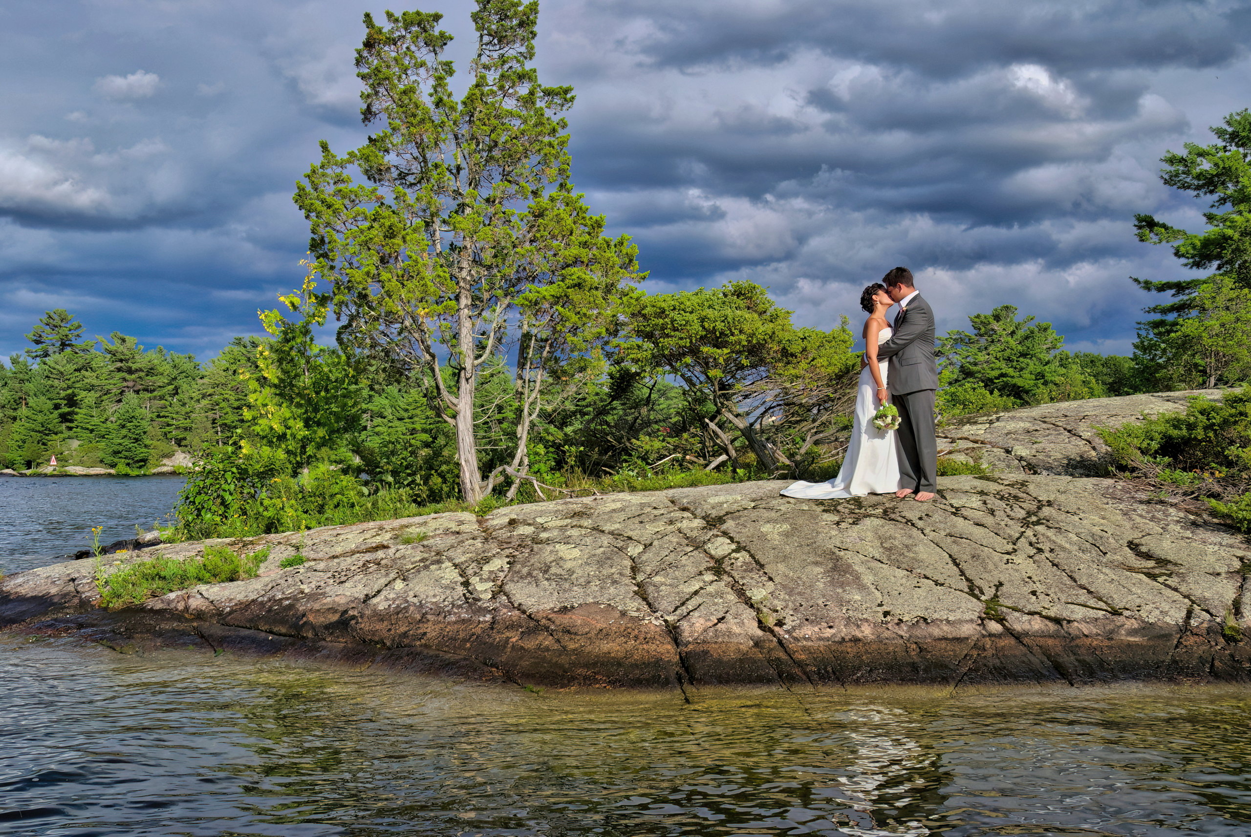 Newlyweds kiss on Rocky Island in Stoney Lake, near Lakefield