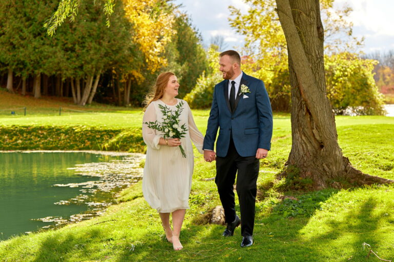 Bride and Groom Walking Together at the Briars Golf Club on a sunny fall day